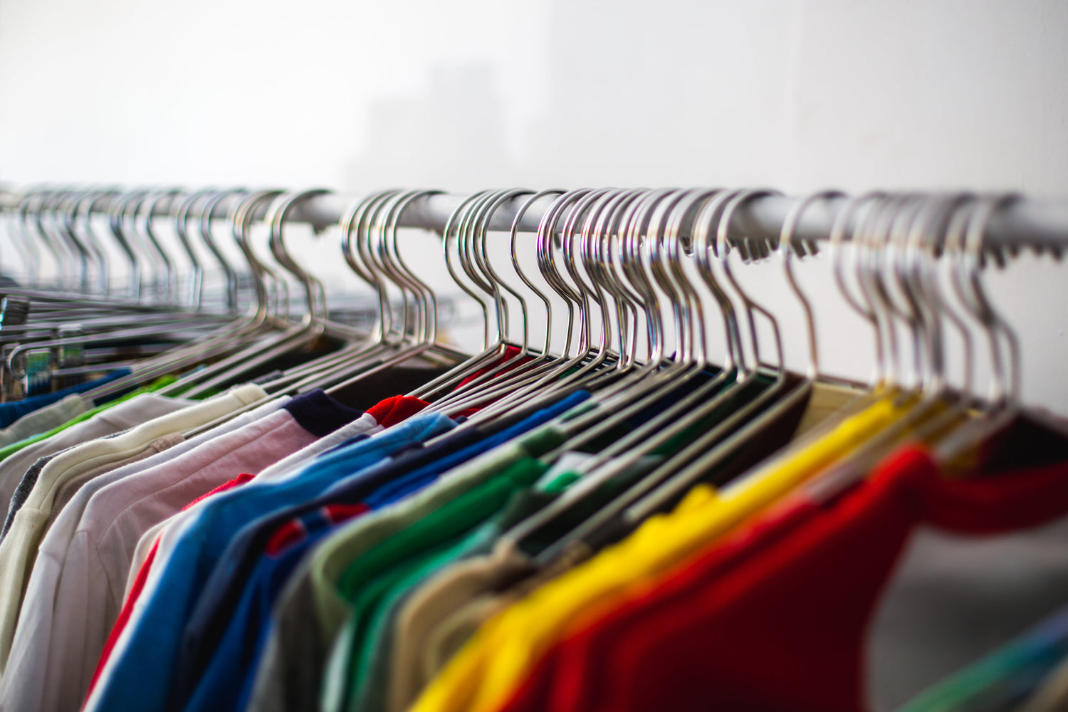 multi-colored shirts on hangers